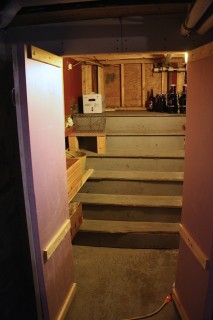 The wooden wall in back used to be the door to the outside; the insulated doors keep the cold in the root cellar.